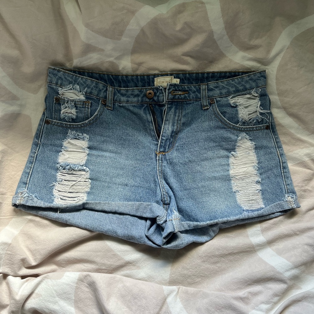 Timing classic blue jeans with distressing size large